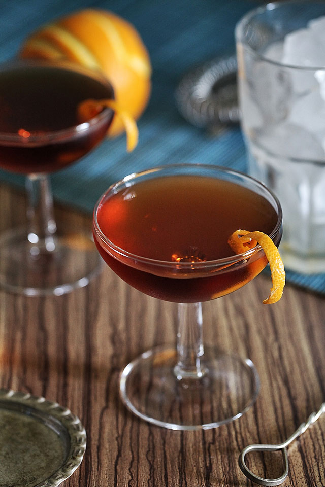 The Martinez Cocktail served in a beauty coupe garnished with an orange twist 